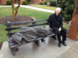  Rev. David Buck sits next to the Jesus the Homeless statue that was installed in front of his church, St. Alban's Episcopal, in Davidscon, N.C.